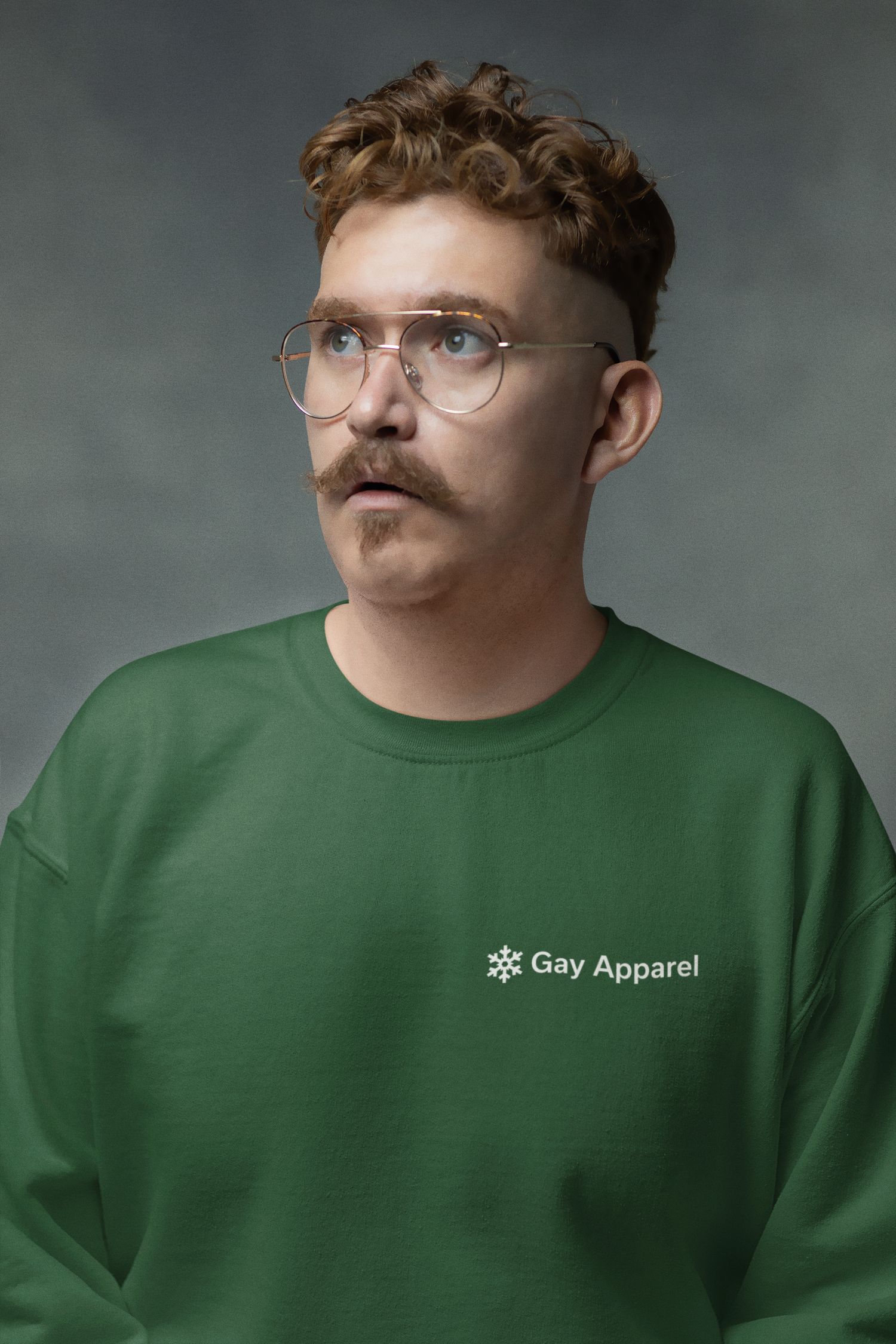 Man wearing a green sweatshirt with 'Gay Apparel' logo against a gray background